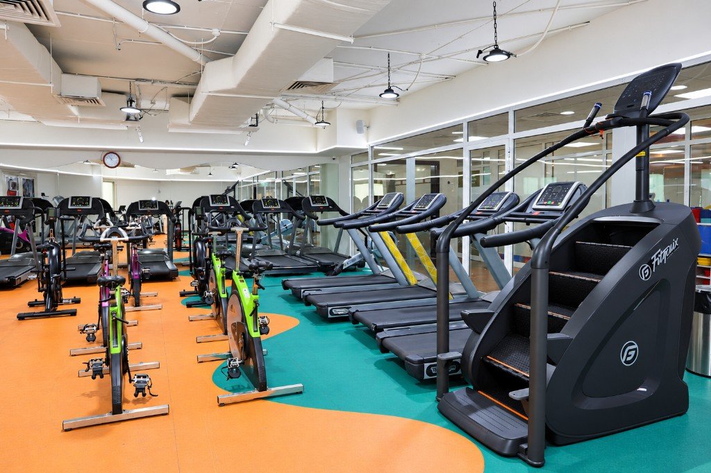 Cardio studio with spin bikes, treadmills, and a stair climber