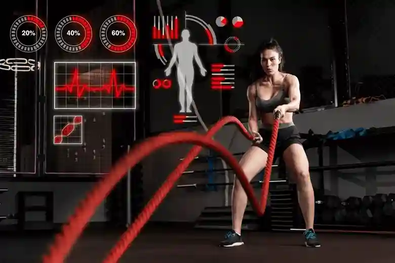 Woman doing a battle rope workout with heart-rate and body-stats graphics overlaid