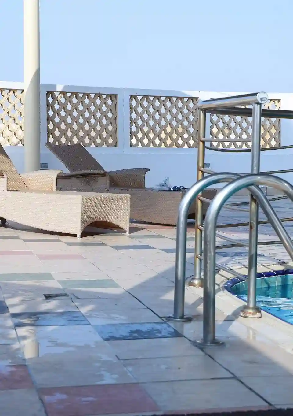 Family swimming pool with steel ladder and sun loungers at Zarya Wellness Health Club, Al Qusais